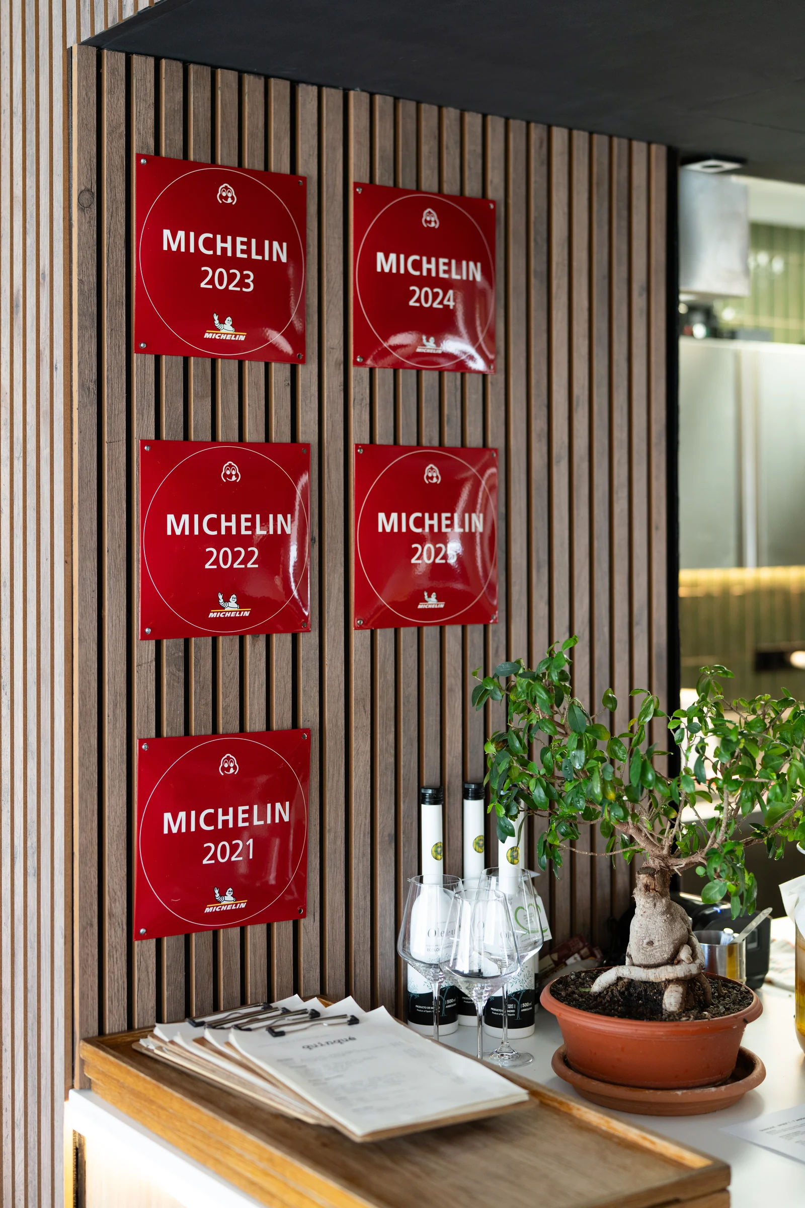 MICHELIN Guide Bib Gourmand plaques on the wooden wall